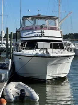 Slide: The Image of 1995 Jefferson 48 Rivanna yacht docked at marina with inflatable boat nearby. - 33