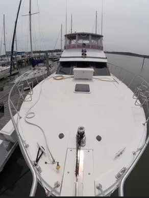 Slide: The Image of 1995 Jefferson 48 Rivanna yacht docked at marina, showcasing spacious deck and sleek design. - 5