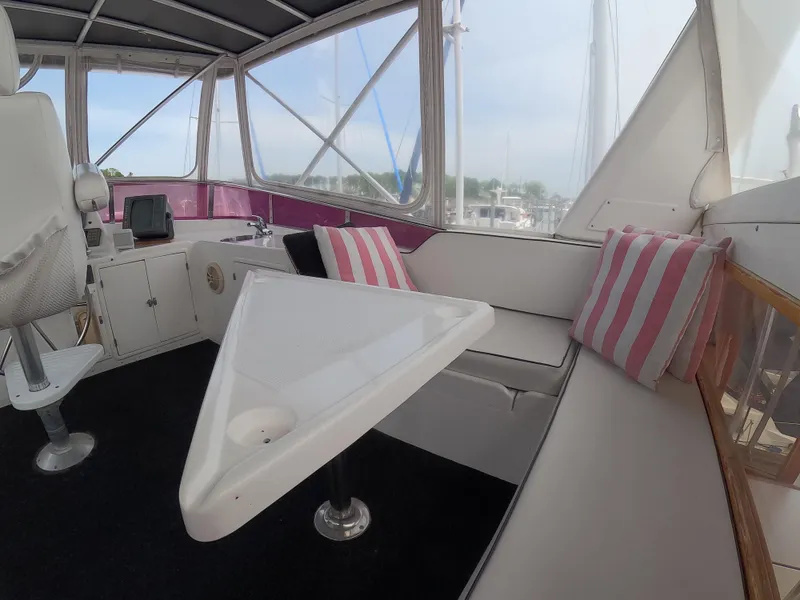 Slide: The Image of Interior of 1995 Jefferson 48 Rivanna yacht with seating and striped cushions. - 9