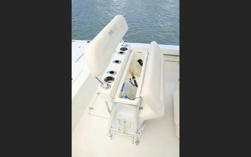 Slide: The Image of 2025 Pathfinder 2200 TRS boat seating with storage and cup holders on deck. - 12