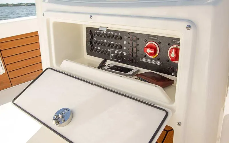 Slide: The Image of Control panel of 2025 Pathfinder 2200 TRS boat with switches and storage compartment. - 16