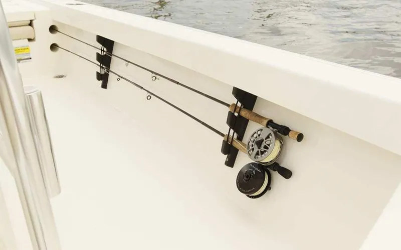Slide: The Image of Fishing rods secured on a 2025 Pathfinder 2200 TRS boat, ready for a fishing adventure. - 17
