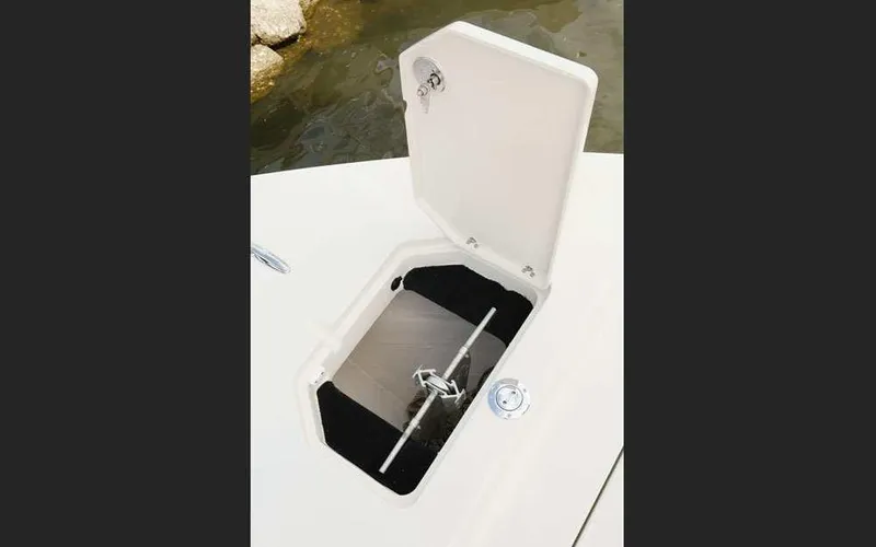 Slide: The Image of Open hatch on 2025 Pathfinder 2200 TRS boat, revealing anchor storage. - 18