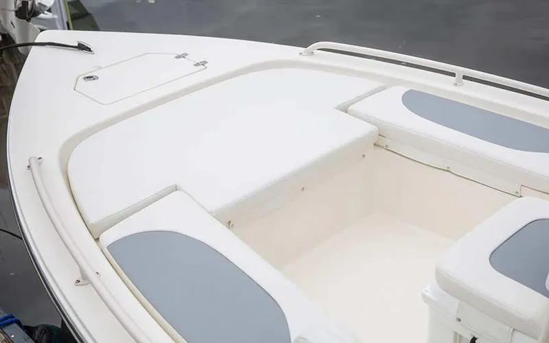 Slide: The Image of 2025 Pathfinder 2200 TRS boat interior with cushioned seating and storage compartments. - 4