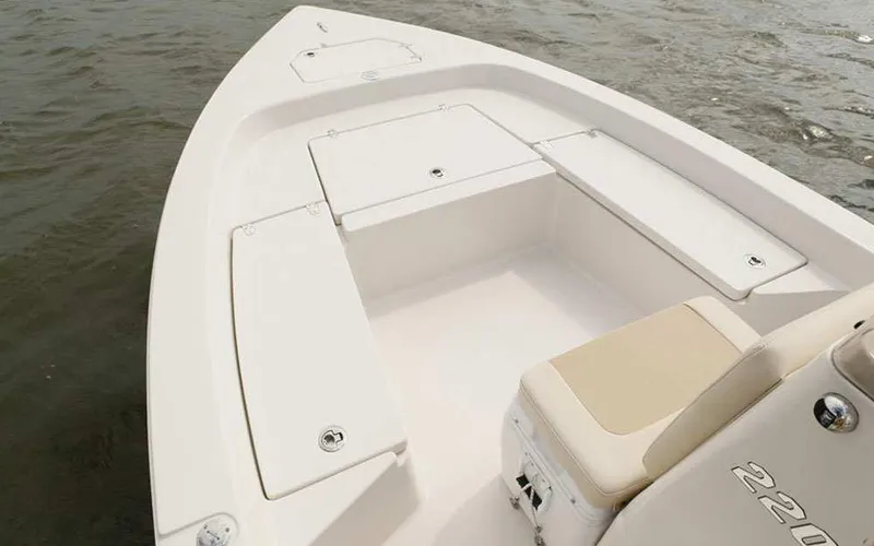 Slide: The Image of 2025 Pathfinder 2200 TRS boat interior with storage compartments on calm water. - 6