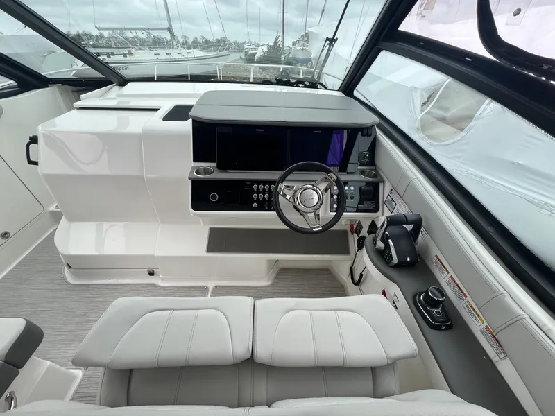 Slide: The Image of 2023 Sea Ray Sundancer 320 helm with modern controls and sleek design. - 18