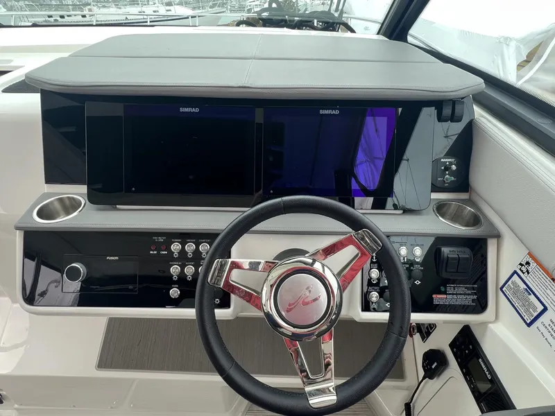 Slide: The Image of 2023 Sea Ray Sundancer 320 helm with modern controls and dual displays. - 20