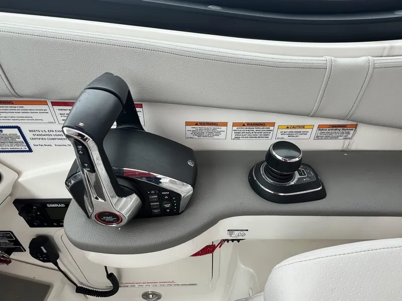 Slide: The Image of Control panel of 2023 Sea Ray Sundancer 320 boat with throttle and joystick. - 21