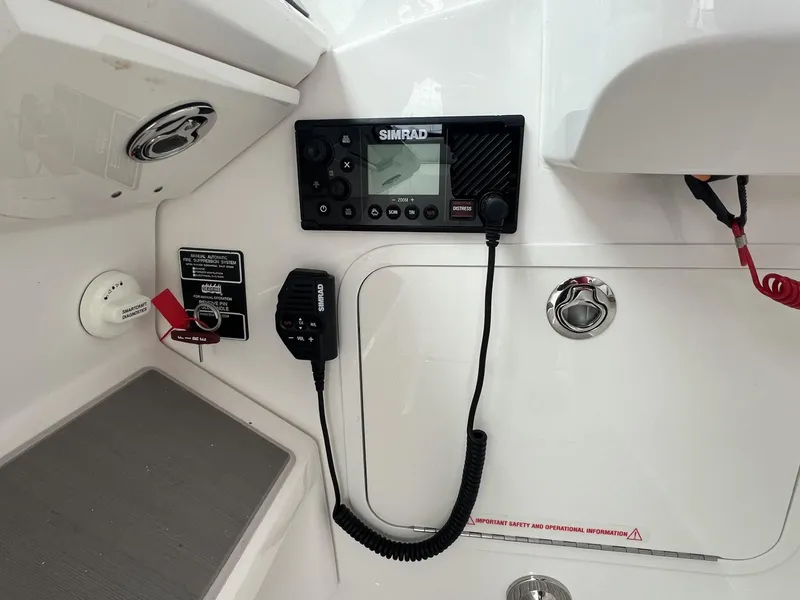 Slide: The Image of 2023 Sea Ray Sundancer 320 boat dashboard with Simrad marine radio equipment. - 22