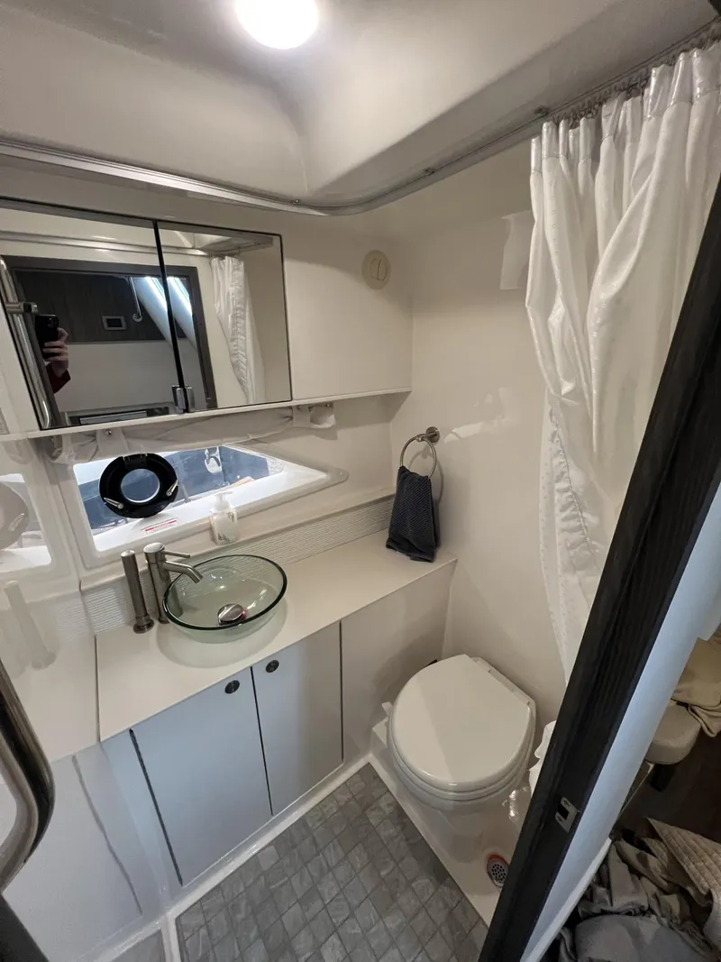 Slide: The Image of 2023 Sea Ray Sundancer 320 bathroom with modern fixtures and glass sink. - 27