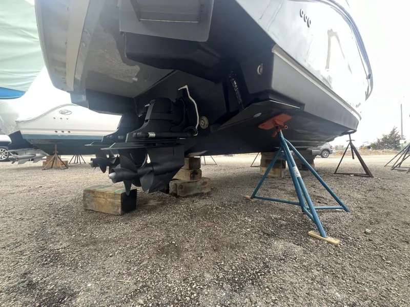 Slide: The Image of 2023 Sea Ray Sundancer 320 boat on stands, showing propeller and hull details. - 29