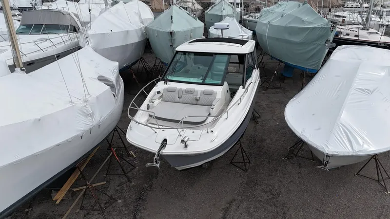 Slide: The Image of 2023 Sea Ray Sundancer 320 boat in storage, surrounded by covered boats. - 3