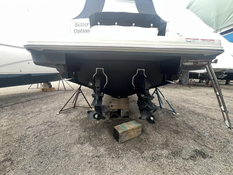 Slide: The Image of 2023 Sea Ray Sundancer 320 boat on dry dock, rear view with dual propellers. - 30