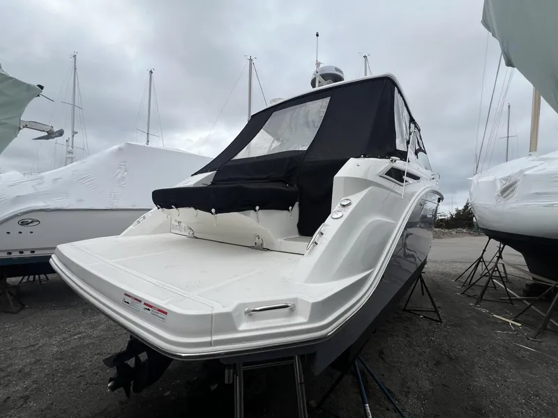 Slide: The Image of 2023 Sea Ray Sundancer 320 boat with covered deck, docked on land. - 8