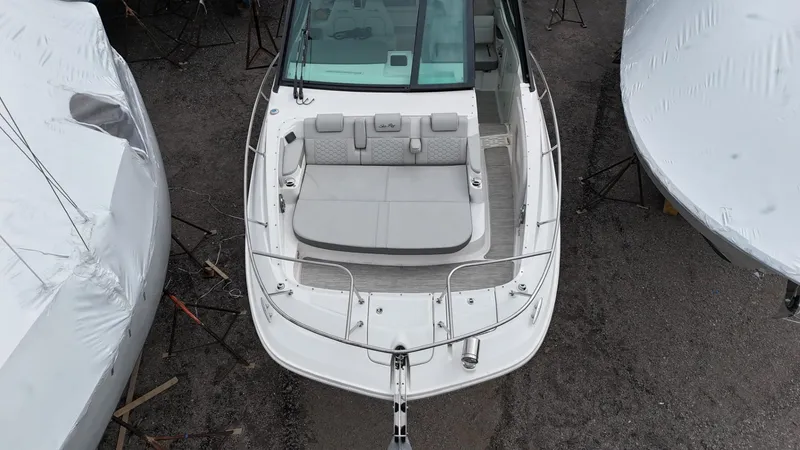 Slide: The Image of 2023 Sea Ray Sundancer 320 boat, aerial view, docked with protective covers nearby. - 9