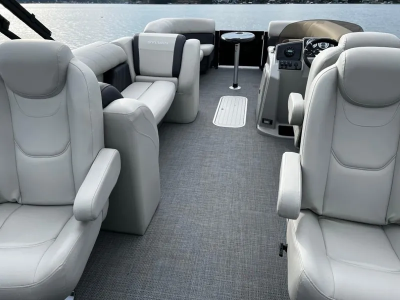 Slide: The Image of 2025 Sylvan Mirage X3 Party Fish boat interior with plush seating and modern controls. - 10