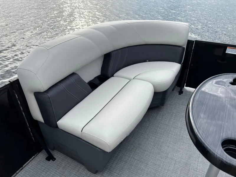 Slide: The Image of Luxurious seating on 2025 Sylvan Mirage X3 Party Fish pontoon boat, overlooking water. - 12