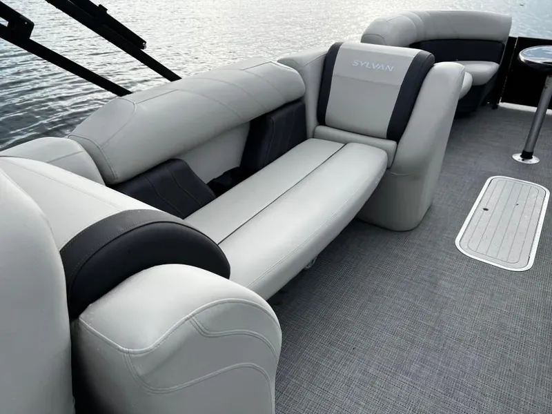 Slide: The Image of 2025 Sylvan Mirage X3 Party Fish boat interior with luxurious seating and water view. - 13