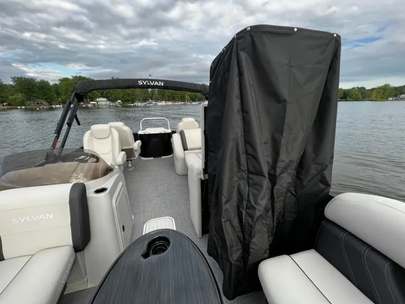Slide: The Image of 2025 Sylvan Mirage X3 Party Fish pontoon boat interior on a lake. - 18