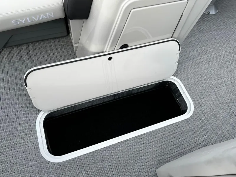 Slide: The Image of Open storage compartment on 2025 Sylvan Mirage X3 Party Fish boat, featuring sleek interior design. - 19