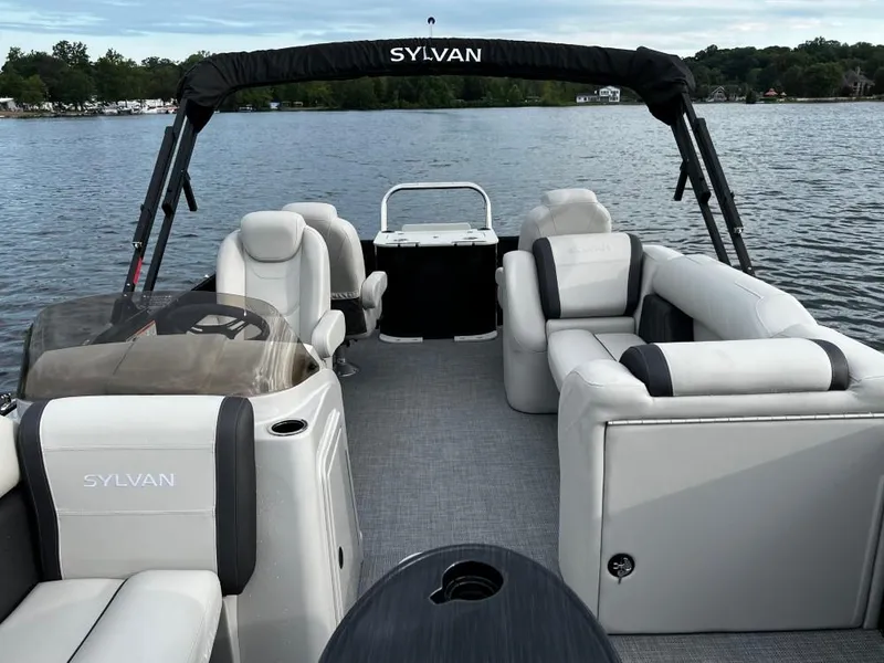 Slide: The Image of 2025 Sylvan Mirage X3 Party Fish pontoon boat on a serene lake. - 3