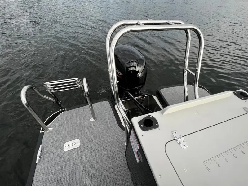 Slide: The Image of 2025 Sylvan Mirage X3 Party Fish boat with motor and swim platform on water. - 4