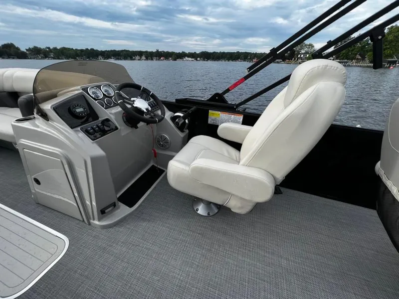 Slide: The Image of 2025 Sylvan Mirage X3 Party Fish boat interior with captain's chair and control panel. - 5