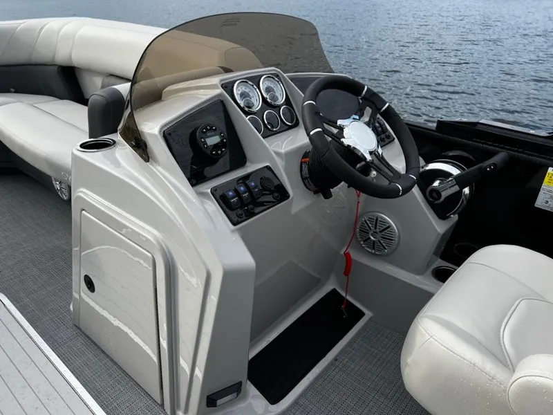 Slide: The Image of 2025 Sylvan Mirage X3 Party Fish boat dashboard with steering wheel and controls. - 6