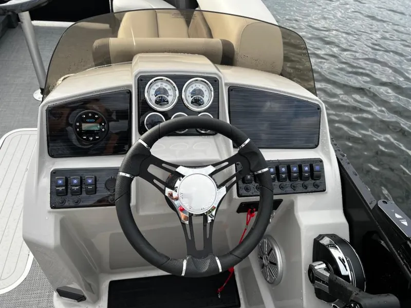 Slide: The Image of 2025 Sylvan Mirage X3 Party Fish boat dashboard with steering wheel and controls. - 7