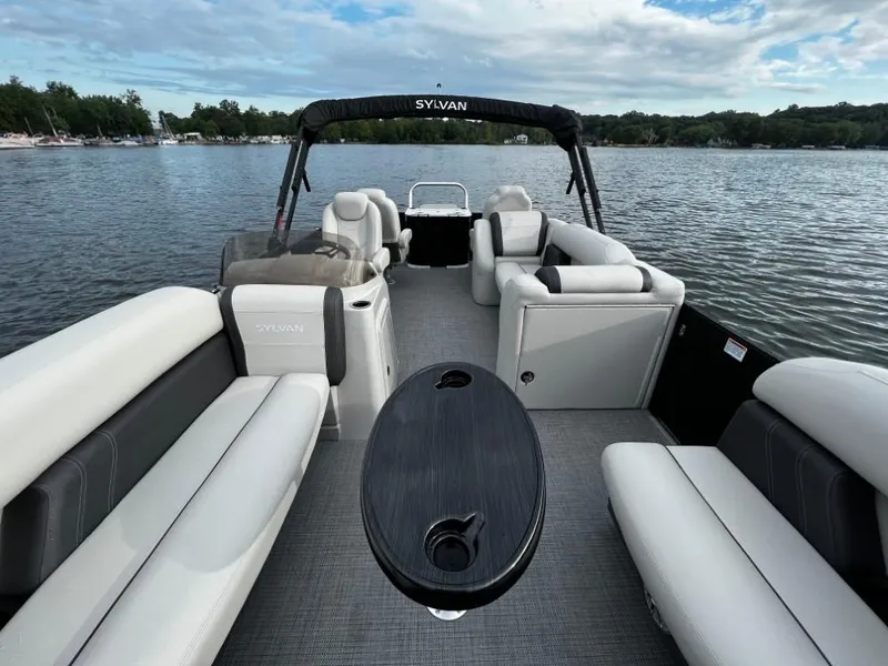 Slide: The Image of 2025 Sylvan Mirage X3 Party Fish pontoon boat on a serene lake. - 8