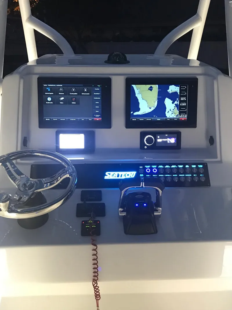 Slide: The Image of 2019 Sea Tech 33 boat dashboard with navigation screens and controls. - 10