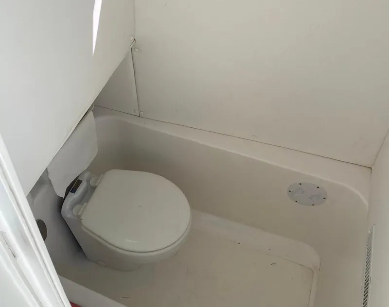 Slide: The Image of Compact marine toilet in a 2019 Sea Tech 33 boat bathroom. - 14