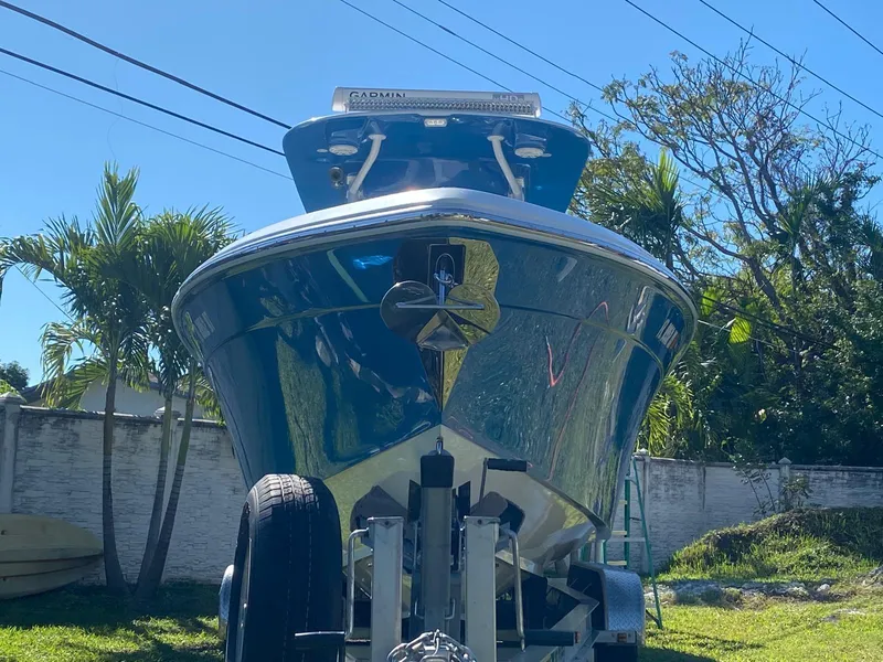 Slide: The Image of 2019 Sea Tech 33 boat on trailer, parked outdoors with palm trees in background. - 20