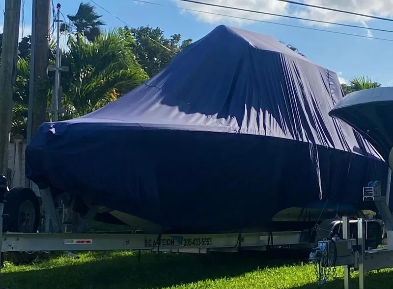 Slide: The Image of Covered 2019 Sea Tech 33 boat on trailer, parked outdoors. - 21