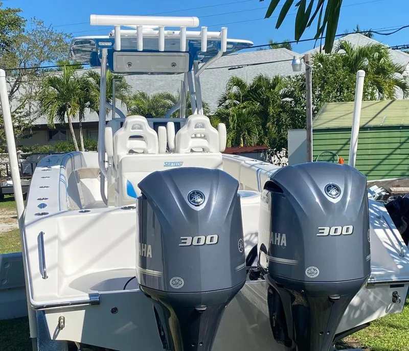 Slide: The Image of 2019 Sea Tech 33 boat with dual Yamaha 300 engines, parked outdoors. - 3