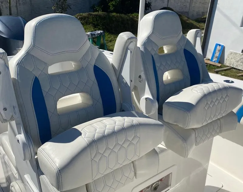 Slide: The Image of Luxury white and blue boat seats on a 2019 Sea Tech 33 model. - 5
