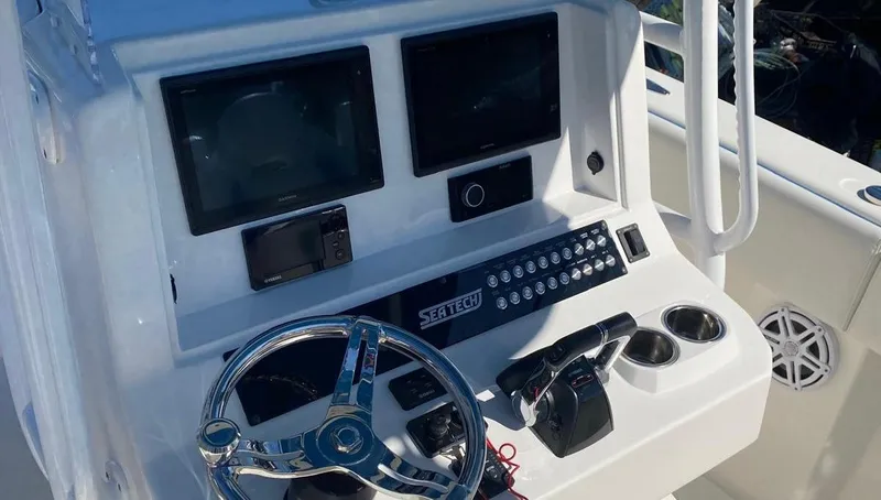 Slide: The Image of Cockpit of 2019 Sea Tech 33 boat with steering wheel and control panel. - 7