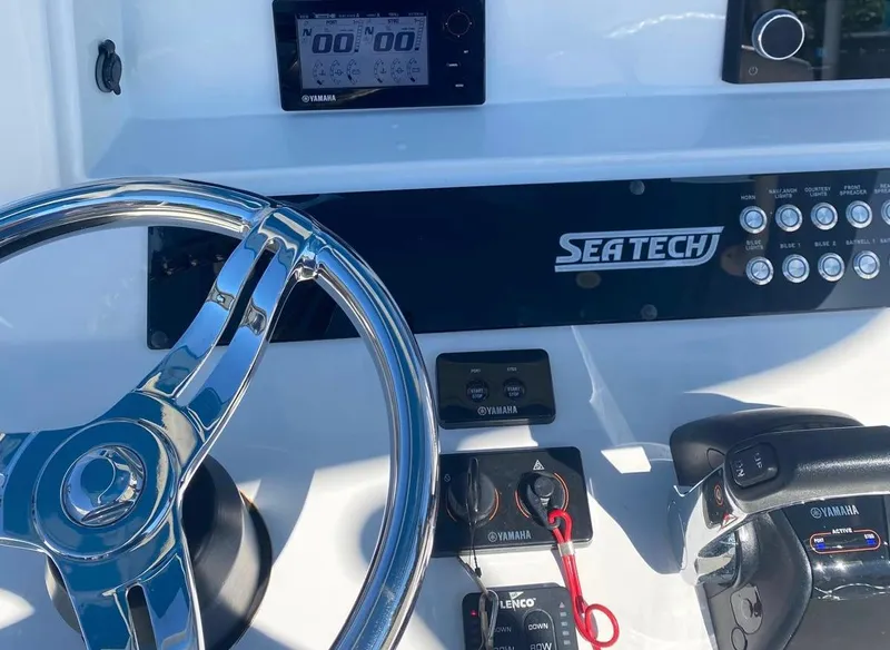 Slide: The Image of Control panel of 2019 Sea Tech 33 boat with steering wheel and Yamaha controls. - 8