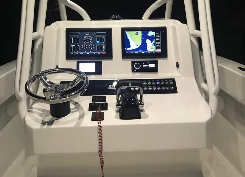 Slide: The Image of 2019 Sea Tech 33 boat dashboard with navigation screens and steering wheel. - 9