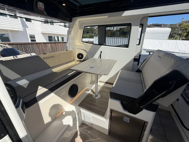 Slide: The Image of Interior of 2025 Navan C30 boat with seating and table, showcasing modern design. - 14