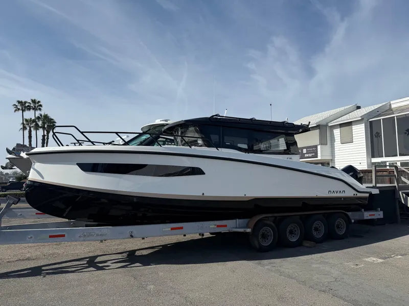 Slide: The Image of 2025 Navan C30 boat on trailer, parked outdoors under clear sky. - 2