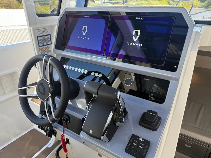 Slide: The Image of 2025 Navan C30 boat dashboard with dual Simrad displays and modern steering wheel. - 23
