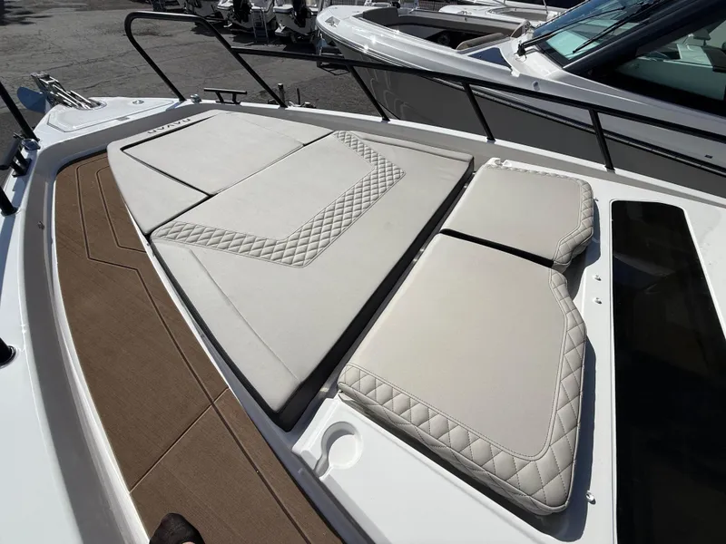 Slide: The Image of 2025 Navan C30 boat with cushioned deck seating and elegant diamond stitching. - 24