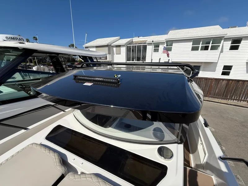 Slide: The Image of 2025 Navan C30 boat with sleek black roof, docked near white buildings. - 26