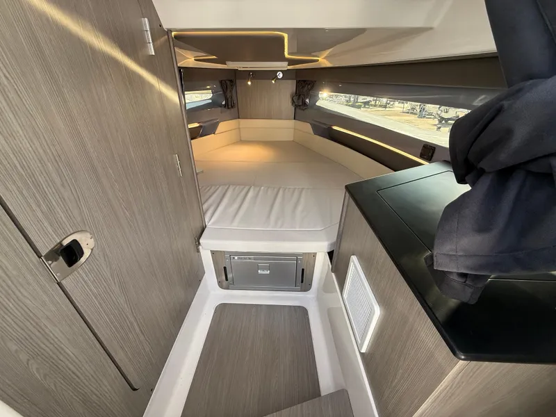 Slide: The Image of 2025 Navan C30 interior cabin with modern design, featuring a cozy bed and sleek wood finishes. - 27