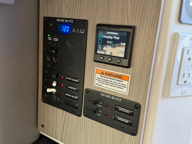 Slide: The Image of Control panel of a 2025 Navan C30, displaying voltage and charging status. - 32