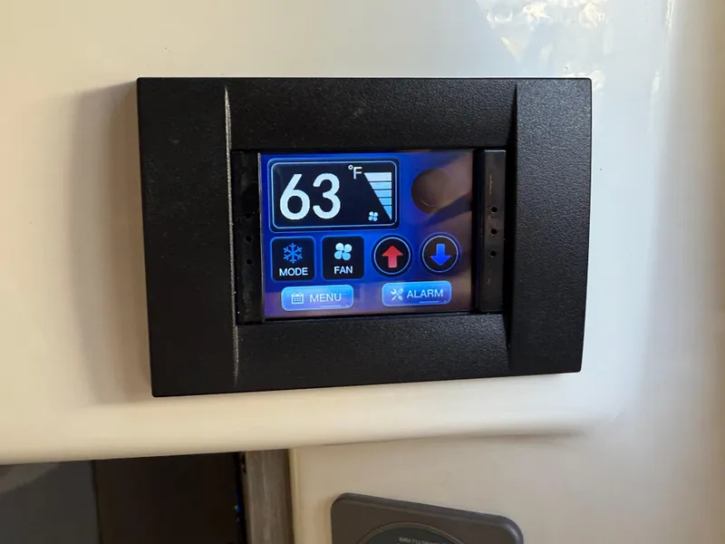 Slide: The Image of Digital thermostat display set to 63°F in Navan C30, 2025 model. - 33