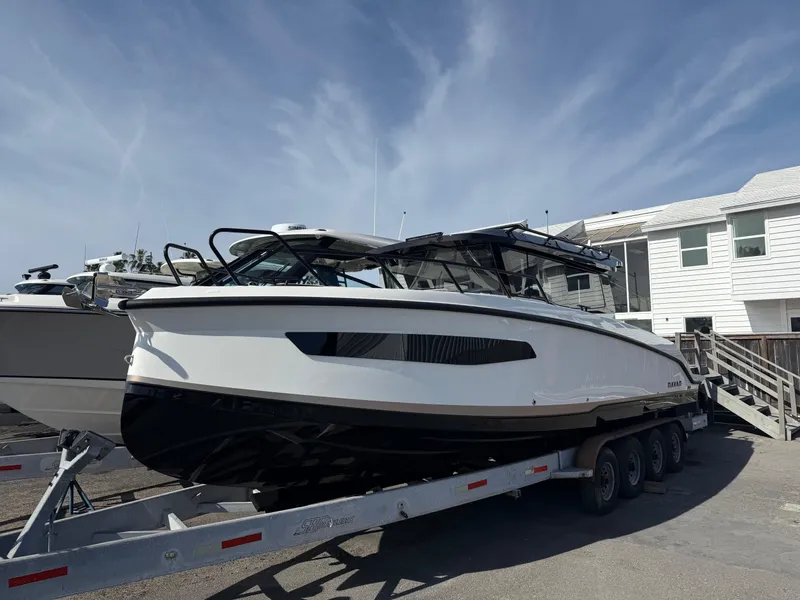 Slide: The Image of 2025 Navan C30 boat on trailer, parked outdoors near modern building. - 4