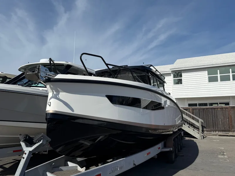 Slide: The Image of 2025 Navan C30 boat on trailer, parked outdoors under a clear blue sky. - 5