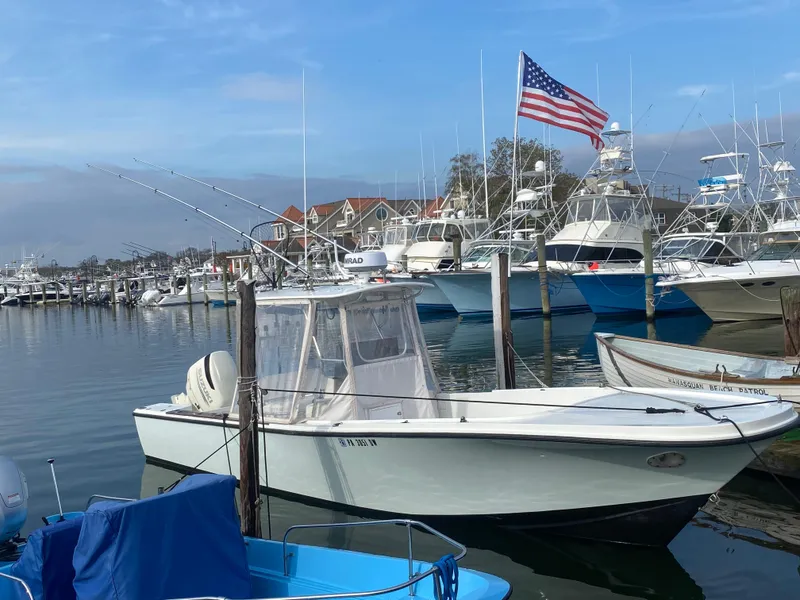 Slide: The Image of 1982 Master Marine 28 Center Console boat docked in a marina with American flag. - 10
